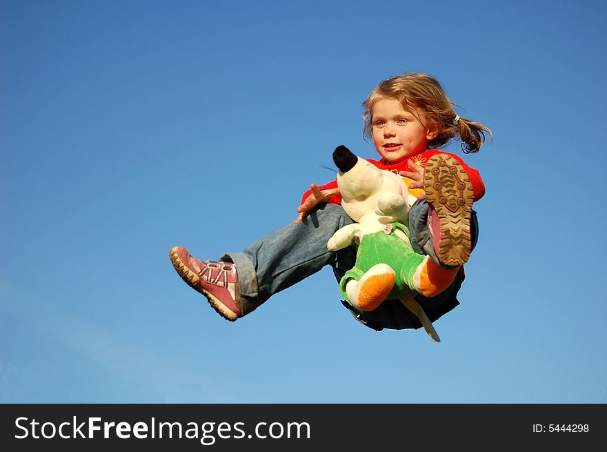 Flying pretty girl, holding toy in hands. Flying pretty girl, holding toy in hands