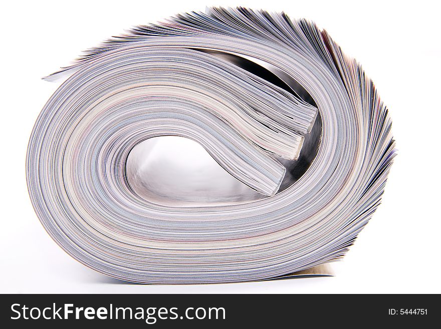 Three rolled magazines on white background