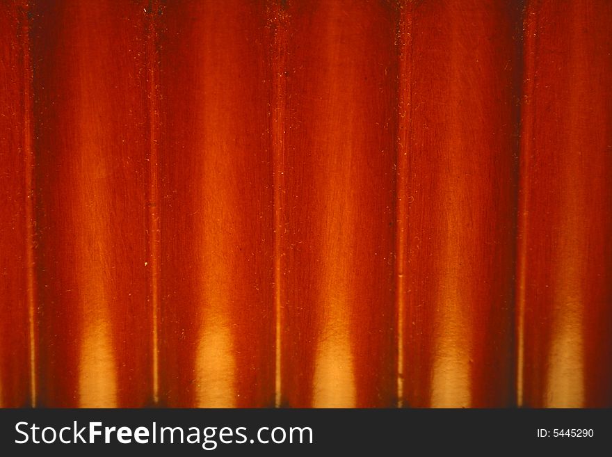 A image of a wood background with a reddish hue.