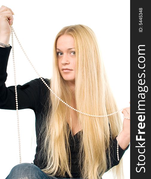 Portrait of the beautiful blond woman with a pearl necklace in her hands. Portrait of the beautiful blond woman with a pearl necklace in her hands