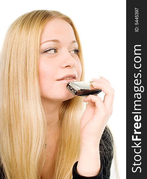Portrait of the beautiful smiling blond woman with a harmonica in her hand