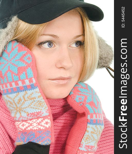 Pretty blue-eyed blonde in fur cap, pink scarf and mitten