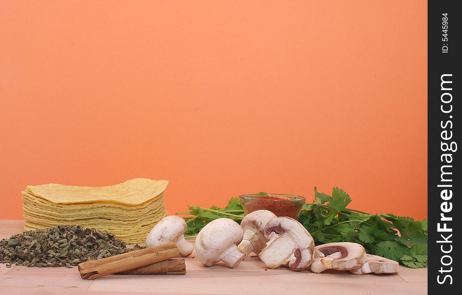 Mushrooms, Cilantro, and Tortillas on Orange Background. Mushrooms, Cilantro, and Tortillas on Orange Background