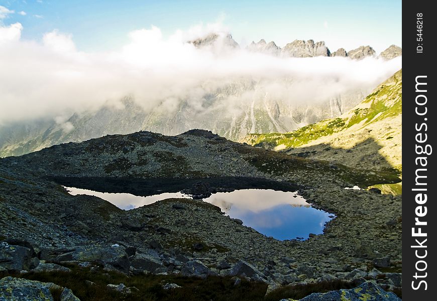 Clouds under mountain top, small beauty pond in Tatra. Clouds under mountain top, small beauty pond in Tatra