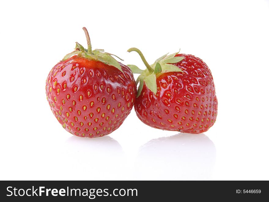 Ripe strawberry with reflection on a plate