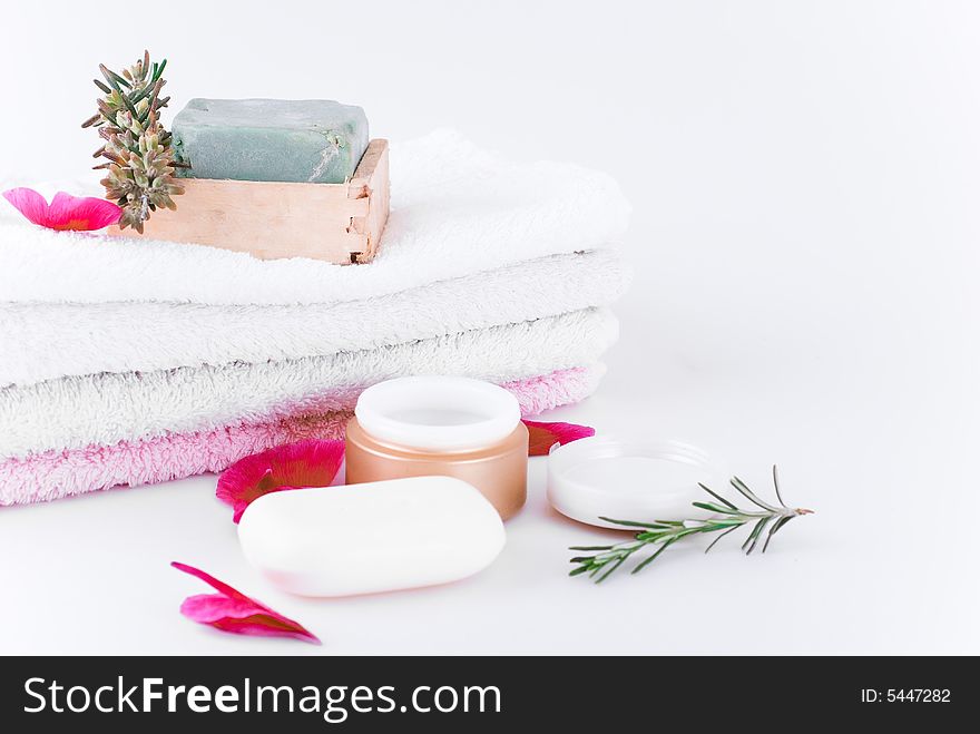 Soft coton towels, olive soap, herbs and pomade on the white background. Soft coton towels, olive soap, herbs and pomade on the white background