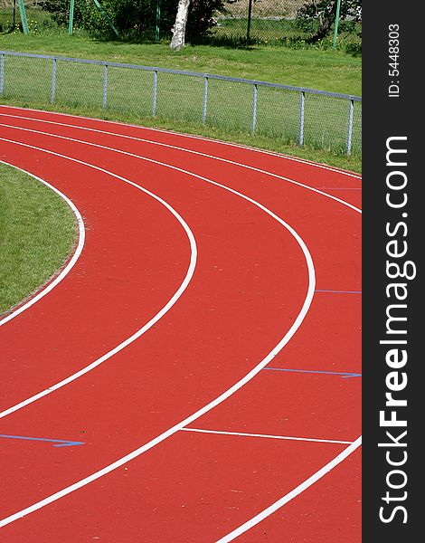 An outdoor running track with four lanes