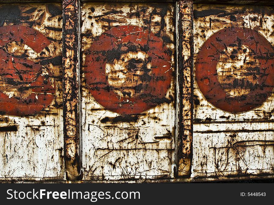 Side of rusted rail car red letters