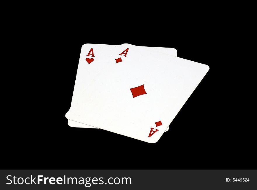 A photograph of pocket aces against a black background