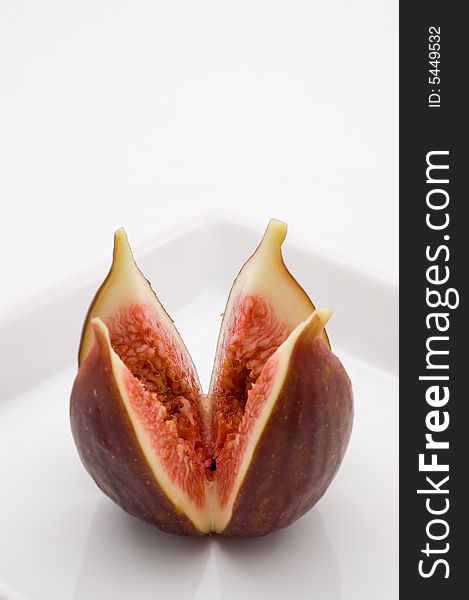 Fresh fig fruit on white plate, studio shot.