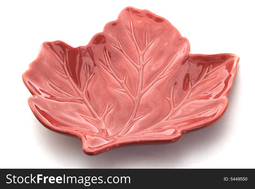 A photograph of a leaf shaped dish against a white background. A photograph of a leaf shaped dish against a white background