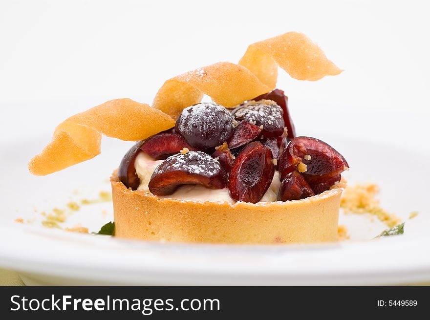 Sweet dessert with cherries and cream, studio shot.