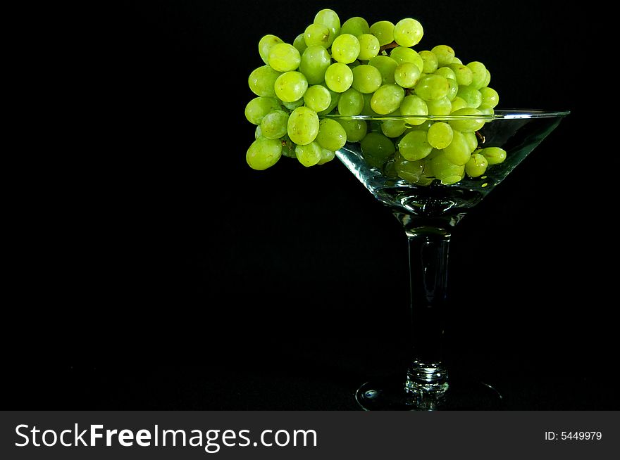 Cluster of green grapes in a large goblet. Cluster of green grapes in a large goblet.