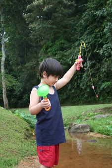 Boy Catching Fish Stock Photos