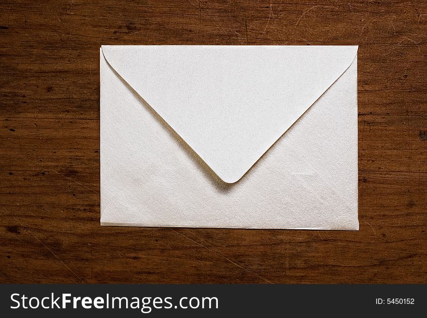 White envelope on wooden surface. White envelope on wooden surface.