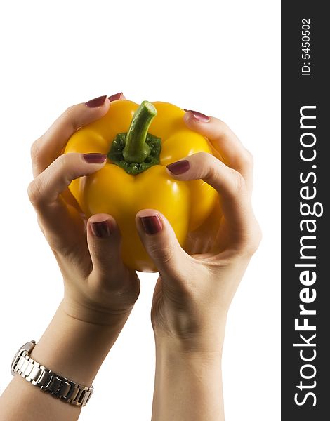 Yellow pepper in a womanish hand with violet nails