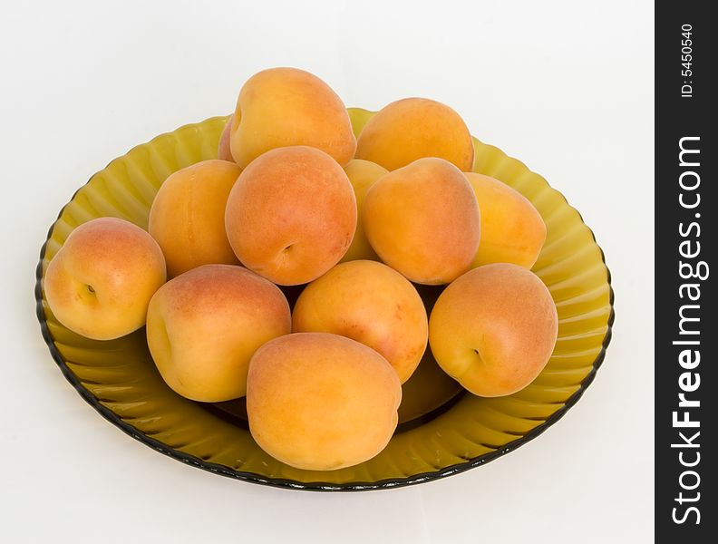 Ripe apricots on a dish from brown glass