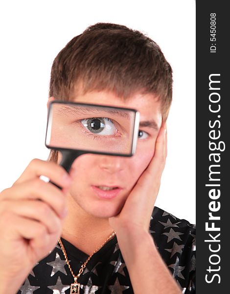 Young man looks through magnifier on white