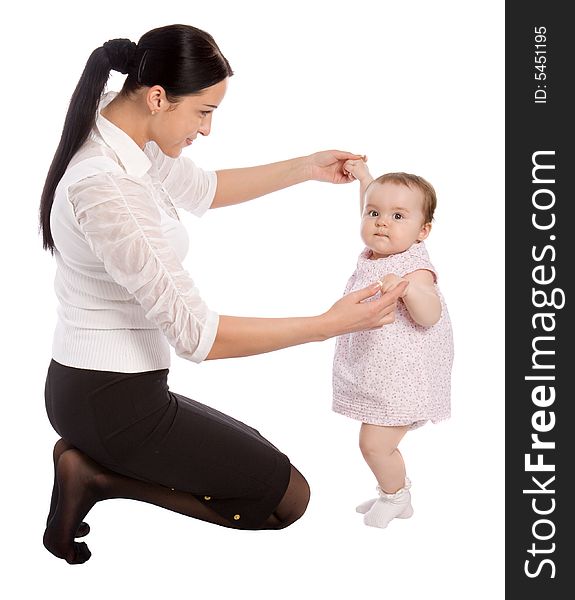 A young mother teaches his daughter to walk