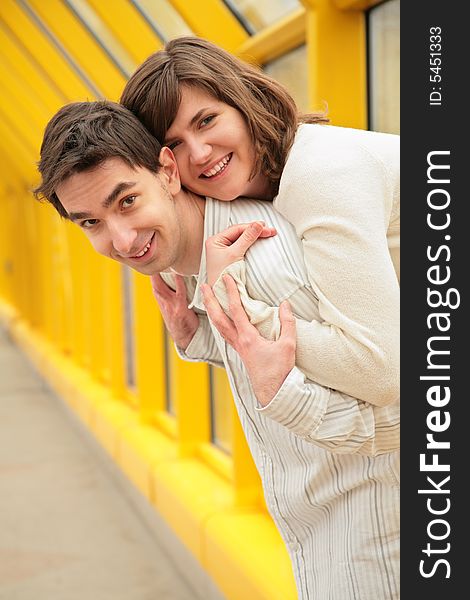 Girl Embraces Boy On  Footbridge