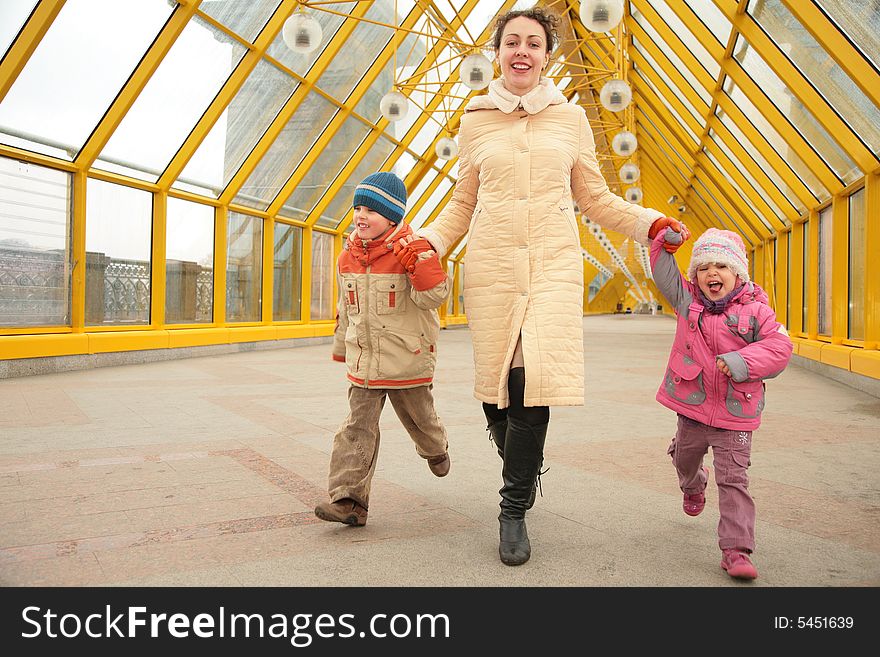 Mother with children on yellow footbridge. Mother with children on yellow footbridge
