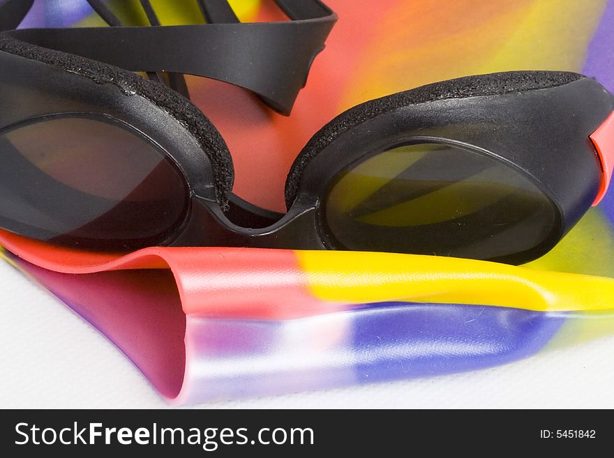 Swimming cap & goggles isolated on white