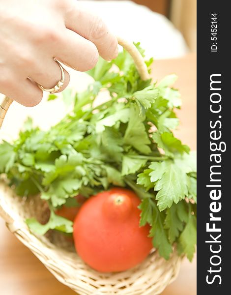 Woman hand holding basket with fresh tomato and parsley. Woman hand holding basket with fresh tomato and parsley