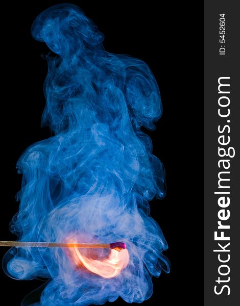 Match with a flame and smoke on dark background. Match with a flame and smoke on dark background