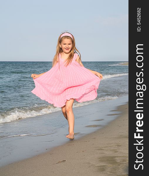 Little girl running at the sandy beach. Little girl running at the sandy beach