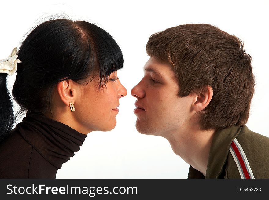 Girl and lad look friend on friend and want to kiss on white background. Girl and lad look friend on friend and want to kiss on white background