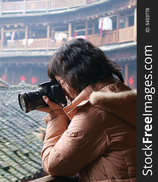 A Chinese girl is photographing. A Chinese girl is photographing.