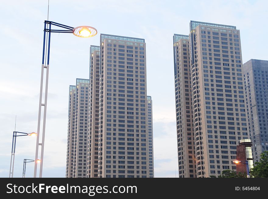 The street lamps and office edifice in the dusk. The street lamps and office edifice in the dusk.