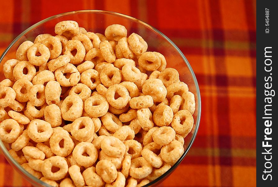 Bowl of breakfast cereal on plaid background