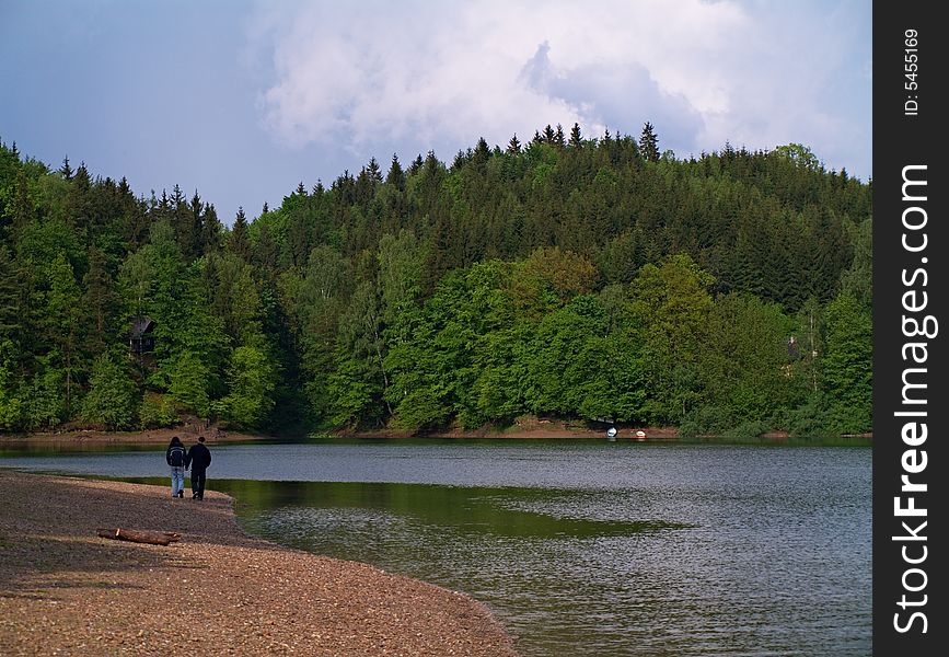 Two young people walking near lake. Two young people walking near lake