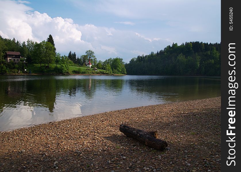 The lake coast with log on it. The lake coast with log on it