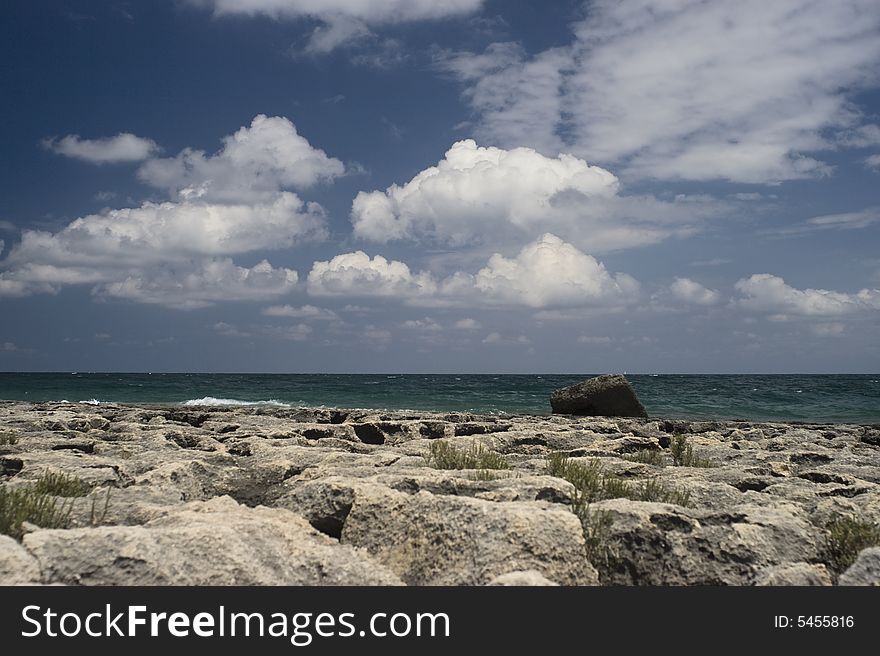 A seaside landscape with rocks, sea and a cloudy sky. A seaside landscape with rocks, sea and a cloudy sky.