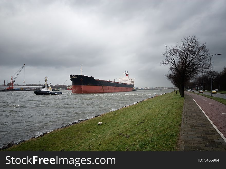 A tugboat and big ship in the canal