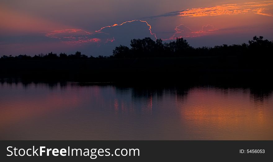 Sunrise caught behind a cloud at Lake Mitchell, South Dakota. Sunrise caught behind a cloud at Lake Mitchell, South Dakota