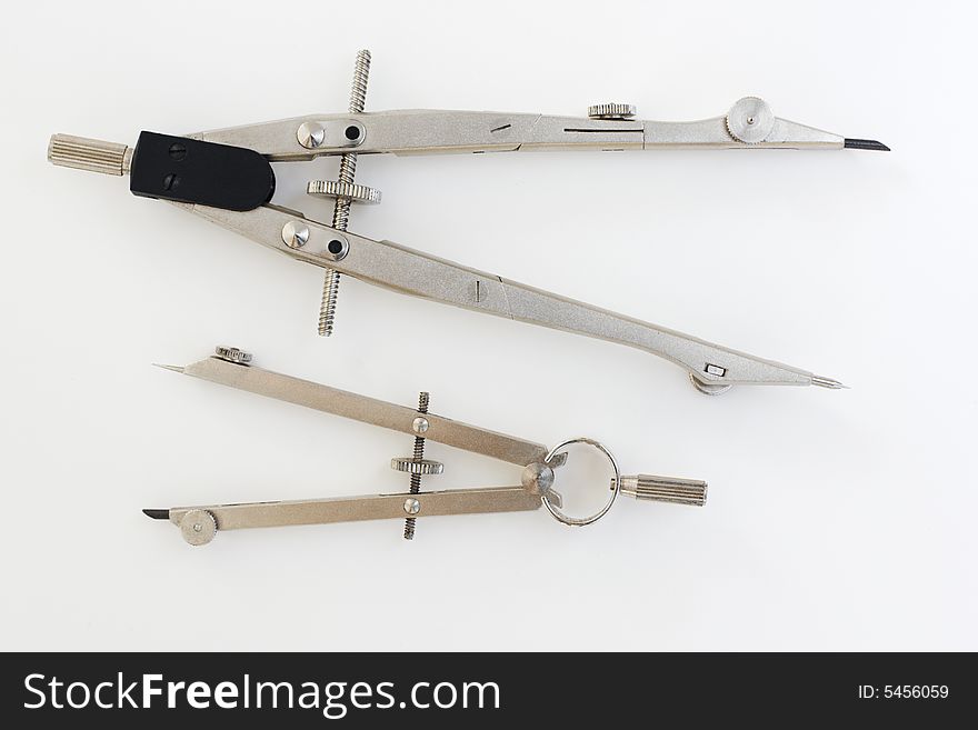 Two pairs of compasses, a drafting instrument used to draw circles. Two pairs of compasses, a drafting instrument used to draw circles
