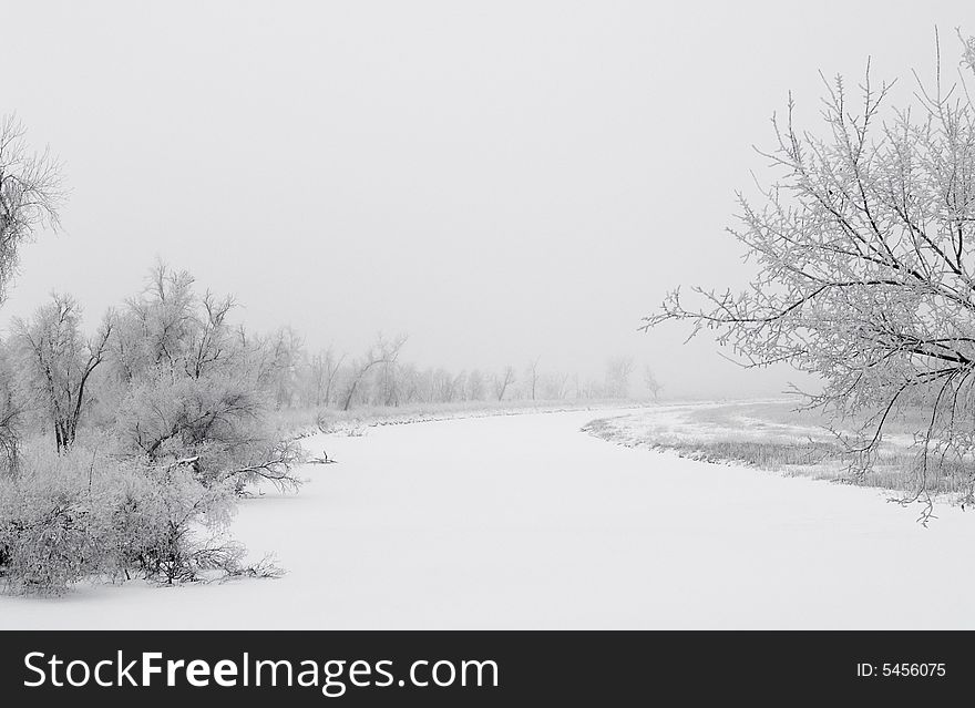 The James river in South Dakota on a frosty and foggy winter morning. The James river in South Dakota on a frosty and foggy winter morning.