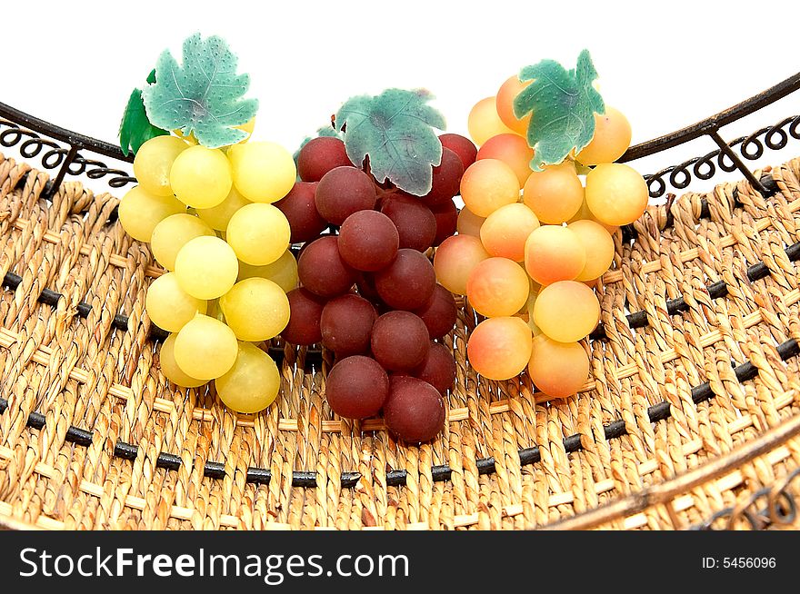 Three bunches of grapes in basket and isolated on white background. Three bunches of grapes in basket and isolated on white background.