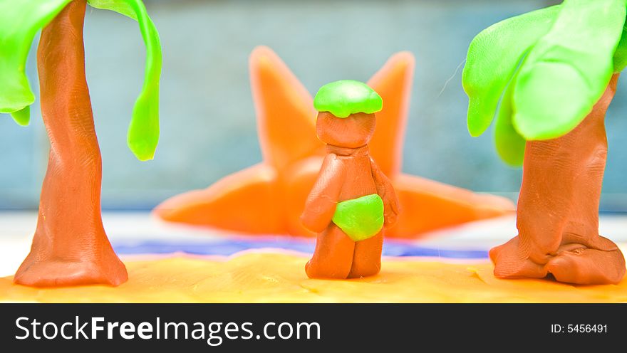 Plasticine tropical island sunrise with man watching