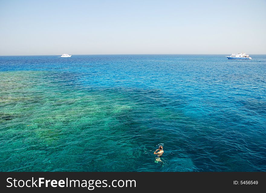 Diver and boats in the Red Sea