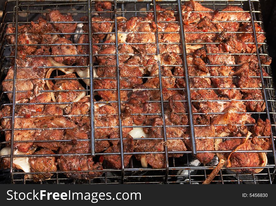 Barbecue. fried meat on a metal lattice