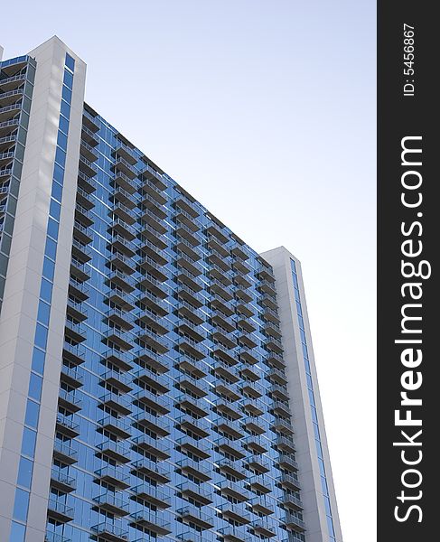 A modern blue high rise apartment building or condos with balconies. A modern blue high rise apartment building or condos with balconies