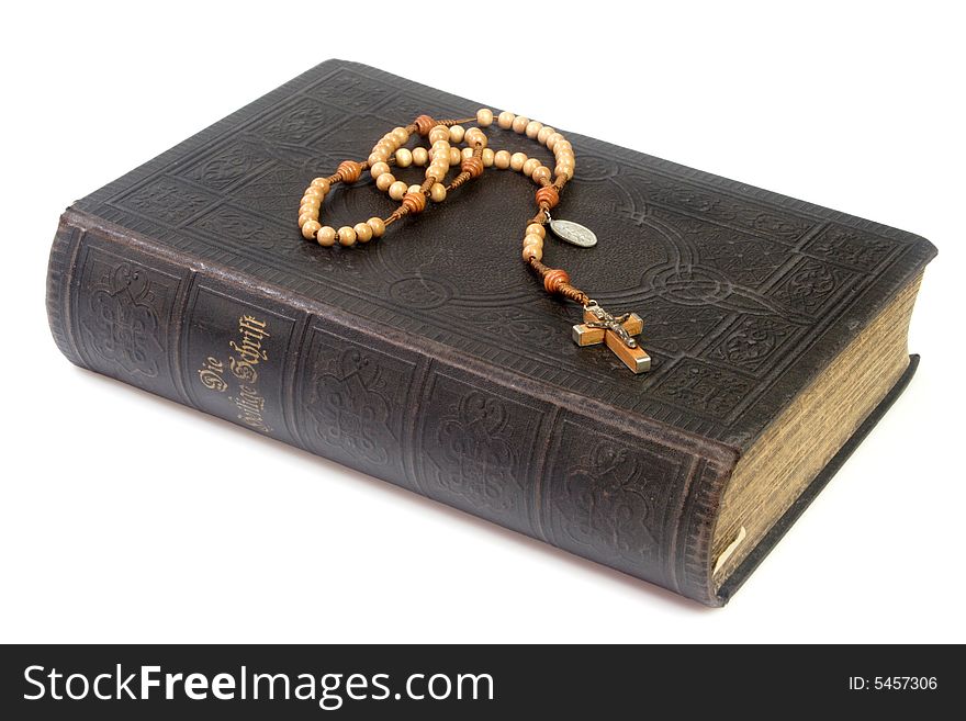 Ancient bible with rosary