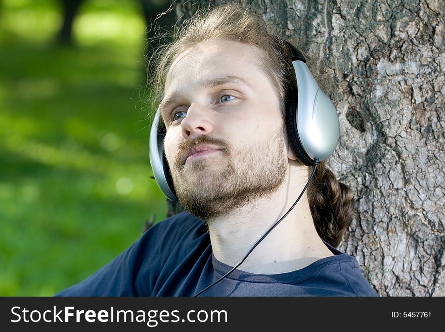 Young man with headphones relaxing (close). Young man with headphones relaxing (close)