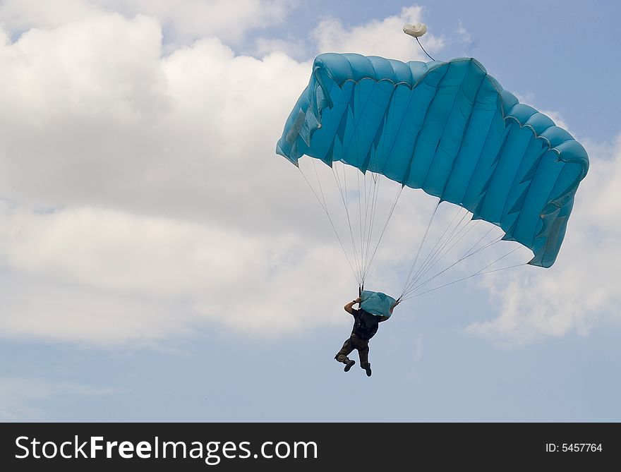 Parachutist jump and cloudy sky