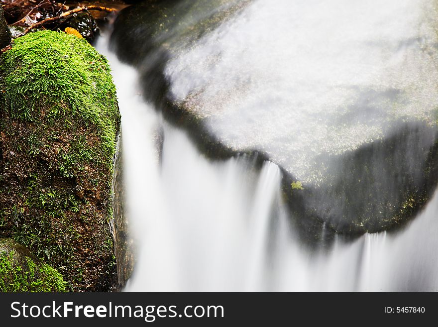 Small waterfall on a creek in the woods; italian alps, europe.