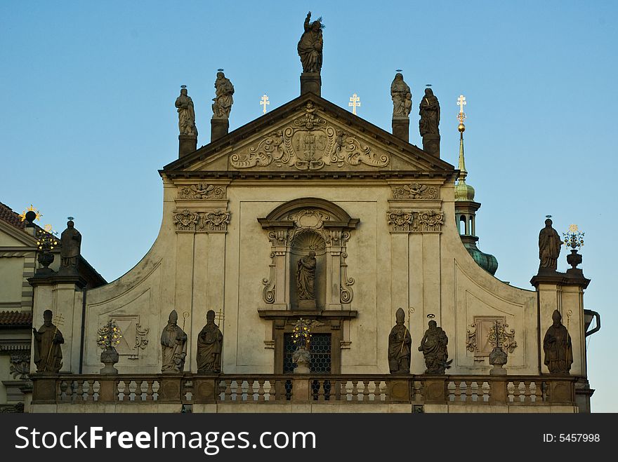 A historic facade, full of statues in the evening sun